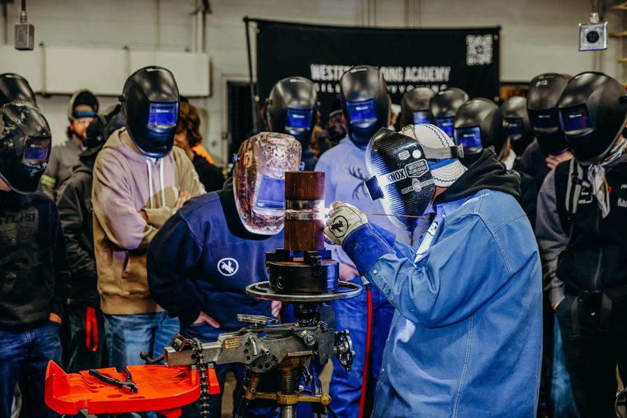 High school students trying welding at the Blue Collar Tour
