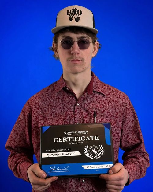 Western Welding Academy graduate holding a certificate