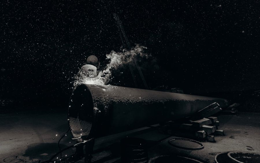 Welding outdoors at night in the snow in Gillette, Wyoming