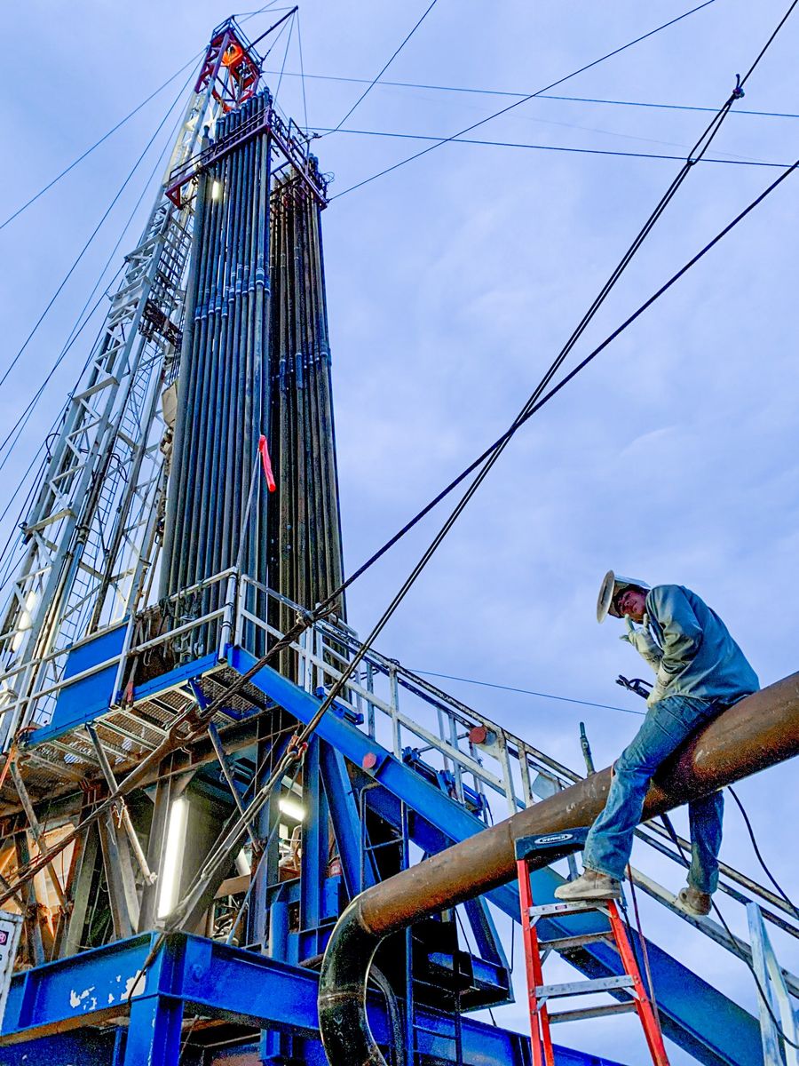 Welder working high on a drilling rig