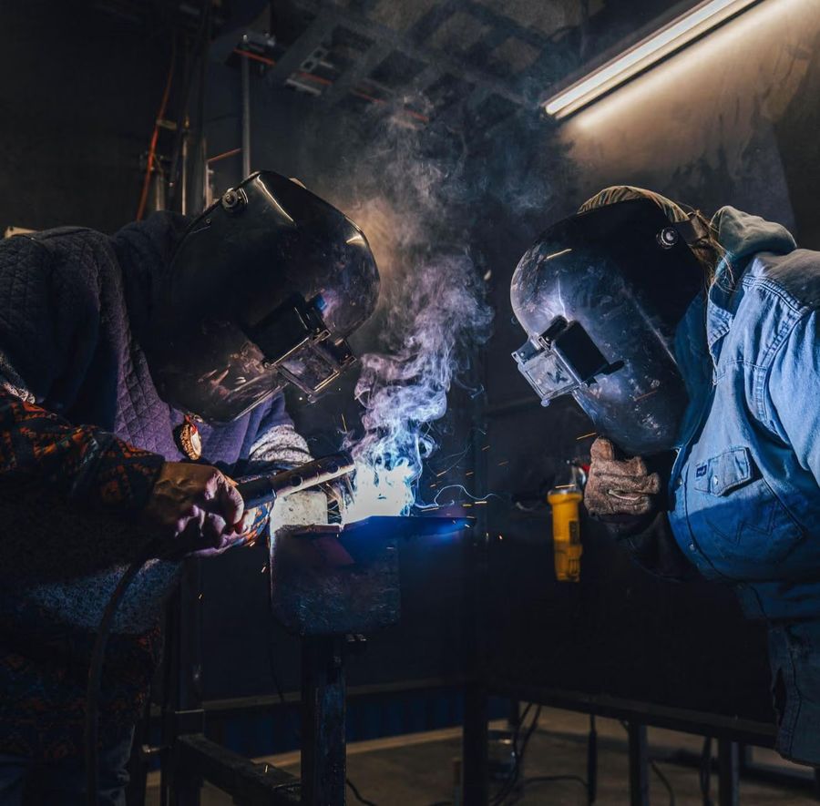 Two Western Welding Academy students welding side by side