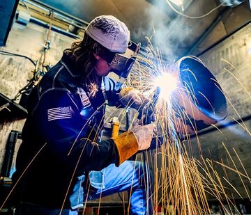 Welder grinding with a shower of sparks